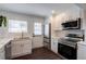 Well-lit kitchen with white cabinets, stainless steel appliances, quartz countertops, subway tile backsplash, and dark wood floors at 4282 Roswell Ne Rd # G1, Atlanta, GA 30342