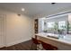 Bright eat-in kitchen features bar seating at the quartz countertop, modern lighting, and a wall-mounted display shelf at 4282 Roswell Ne Rd # G1, Atlanta, GA 30342