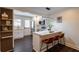 Eat-in kitchen features white cabinets, marble countertops, pendant lighting, and an adjacent wall-mounted display shelf at 4282 Roswell Ne Rd # G1, Atlanta, GA 30342