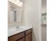 A well-lit bathroom vanity with a white countertop and a framed mirror above the sink at 4467 Sterling Pointe Nw Dr, Kennesaw, GA 30152