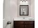 Modern bathroom with a dark vanity, white countertop, mirror and soft towels at 4467 Sterling Pointe Nw Dr, Kennesaw, GA 30152