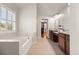 Bright bathroom with a soaking tub, double vanity, and window for natural light at 4467 Sterling Pointe Nw Dr, Kennesaw, GA 30152