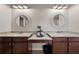 Bathroom featuring double sinks with granite countertops and decorative mirrors at 4467 Sterling Pointe Nw Dr, Kennesaw, GA 30152