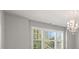 Sunlit room featuring large windows, bright light fixture, and neutral walls at 4467 Sterling Pointe Nw Dr, Kennesaw, GA 30152