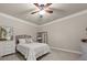 Cozy bedroom featuring a ceiling fan, carpet floors, neutral walls and queen bed at 4467 Sterling Pointe Nw Dr, Kennesaw, GA 30152