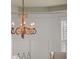 A close up of the wrought iron decorative chandelier over the dining room table at 4467 Sterling Pointe Nw Dr, Kennesaw, GA 30152