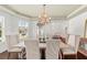 Light and airy dining room with lots of windows and seating for six under an ornate chandelier at 4467 Sterling Pointe Nw Dr, Kennesaw, GA 30152