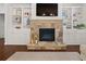 Close up of stone fireplace flanked by built-in shelves with a mounted flatscreen above at 4467 Sterling Pointe Nw Dr, Kennesaw, GA 30152