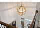 Grand foyer with wood floors, a stylish pendant light, and double doors, from an upstairs view at 4467 Sterling Pointe Nw Dr, Kennesaw, GA 30152