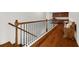 Upstairs hallway showcasing dark hardwood floors, a wooden bench, and natural light, with a view to the front door at 4467 Sterling Pointe Nw Dr, Kennesaw, GA 30152