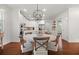 Bright, open kitchen featuring white cabinets, stainless steel appliances, and a large center island with hardwood floors at 4467 Sterling Pointe Nw Dr, Kennesaw, GA 30152