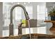 Close up of kitchen sink with pull-down faucet and granite countertops at 4467 Sterling Pointe Nw Dr, Kennesaw, GA 30152