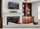 Cozy living room featuring a fireplace with built-in bookshelves and hardwood floors at 4467 Sterling Pointe Nw Dr, Kennesaw, GA 30152