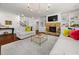 Bright living room with stone fireplace, built-in shelving, hardwood floors, and stylish decor at 4467 Sterling Pointe Nw Dr, Kennesaw, GA 30152