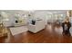 Bright living room featuring hardwood floors, white sofas with colorful pillows, and a fireplace at 4467 Sterling Pointe Nw Dr, Kennesaw, GA 30152