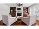 Inviting living room featuring a fireplace, built-in shelving, comfortable seating and hardwood floors at 4467 Sterling Pointe Nw Dr, Kennesaw, GA 30152