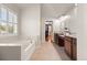 Elegant main bathroom with soaking tub, dual vanities, and modern finishes at 4467 Sterling Pointe Nw Dr, Kennesaw, GA 30152