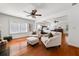 Spacious main bedroom suite with seating area, hardwood floors, and a ceiling fan at 4467 Sterling Pointe Nw Dr, Kennesaw, GA 30152