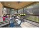 Relaxing screened porch with comfortable seating, a ceiling fan and lovely outdoor views of landscaping at 4467 Sterling Pointe Nw Dr, Kennesaw, GA 30152