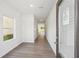 Bright entryway with sleek hardwood flooring, neutral walls, and a clear view into the house at 11840 Rizvan Pl, Covington, GA 30014