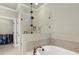 Modern bathroom featuring a soaking tub, a glass-enclosed shower, and a walk-in closet at 226 Chastain Preserve Ne Ln, Atlanta, GA 30342