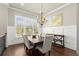 Elegant dining room with hardwood floors, wainscoting and a large bright window at 226 Chastain Preserve Ne Ln, Atlanta, GA 30342