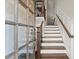 Elegant entryway featuring hardwood stairs with white risers, wooden banisters and a glass paneled front door at 226 Chastain Preserve Ne Ln, Atlanta, GA 30342