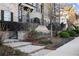 Beautiful townhome with a brick stairway, professional landscaping and a view of the street at 226 Chastain Preserve Ne Ln, Atlanta, GA 30342