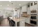 Modern kitchen featuring stainless steel appliances, a large island with barstool seating, and ample cabinet space at 226 Chastain Preserve Ne Ln, Atlanta, GA 30342