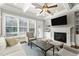 A living room with a coffered ceiling, fireplace, built-in bookshelves, and large windows for natural light at 226 Chastain Preserve Ne Ln, Atlanta, GA 30342