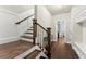 Elegant staircase with hardwood steps and iron balusters leads to the upper floors, with views of the home at 226 Chastain Preserve Ne Ln, Atlanta, GA 30342