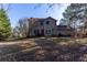 A spacious backyard featuring a well manicured lawn and mature trees at 25 Shadowbrook Ct, Covington, GA 30014