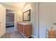Bright bathroom featuring a double sink vanity with a solid surface counter and an adjoined room at 25 Shadowbrook Ct, Covington, GA 30014