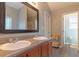 Bright bathroom featuring a double sink vanity with a solid surface counter and new faucets at 25 Shadowbrook Ct, Covington, GA 30014