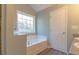 Bright bathroom featuring a bathtub, laminate floors and blue painted walls at 25 Shadowbrook Ct, Covington, GA 30014