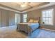 Comfortable bedroom featuring a trey ceiling, a ceiling fan and a large window allowing in plenty of natural light at 25 Shadowbrook Ct, Covington, GA 30014