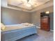Comfortable bedroom featuring a trey ceiling, a ceiling fan, carpet floors, and a wood dresser at 25 Shadowbrook Ct, Covington, GA 30014