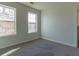Bedroom featuring a gray carpet, neutral paint, and a window for natural light at 25 Shadowbrook Ct, Covington, GA 30014