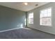 Bright bedroom with natural light shining through the two windows, showing a ceiling fan at 25 Shadowbrook Ct, Covington, GA 30014