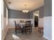 Well-lit dining room featuring wainscoting and ample natural light with views of the living room at 25 Shadowbrook Ct, Covington, GA 30014