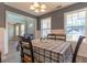 Comfortable dining area with chair rail, modern lighting, and large windows, creating a welcoming space at 25 Shadowbrook Ct, Covington, GA 30014