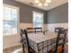 Cozy dining room features large windows and neutral décor, creating a bright and inviting atmosphere at 25 Shadowbrook Ct, Covington, GA 30014