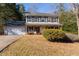 Traditional two-story home featuring a covered front porch, attached garage, and well-maintained landscaping at 25 Shadowbrook Ct, Covington, GA 30014