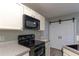 Kitchen featuring range and microwave with barn doors at 25 Shadowbrook Ct, Covington, GA 30014