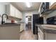 Well-lit kitchen features modern appliances and updated countertops at 25 Shadowbrook Ct, Covington, GA 30014