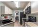 Well-lit kitchen features modern appliances and updated countertops at 25 Shadowbrook Ct, Covington, GA 30014