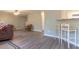 Open concept living room with bar seating and updated flooring at 25 Shadowbrook Ct, Covington, GA 30014
