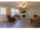 Bright living room featuring a fireplace and large windows at 25 Shadowbrook Ct, Covington, GA 30014