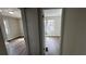 View of two bedrooms featuring wood-look flooring, neutral walls, and natural light through the windows at 110 Raymond St, Jonesboro, GA 30236