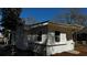 Rear exterior featuring a white painted brick and siding with a fenced in area and manicured lawn at 110 Raymond St, Jonesboro, GA 30236